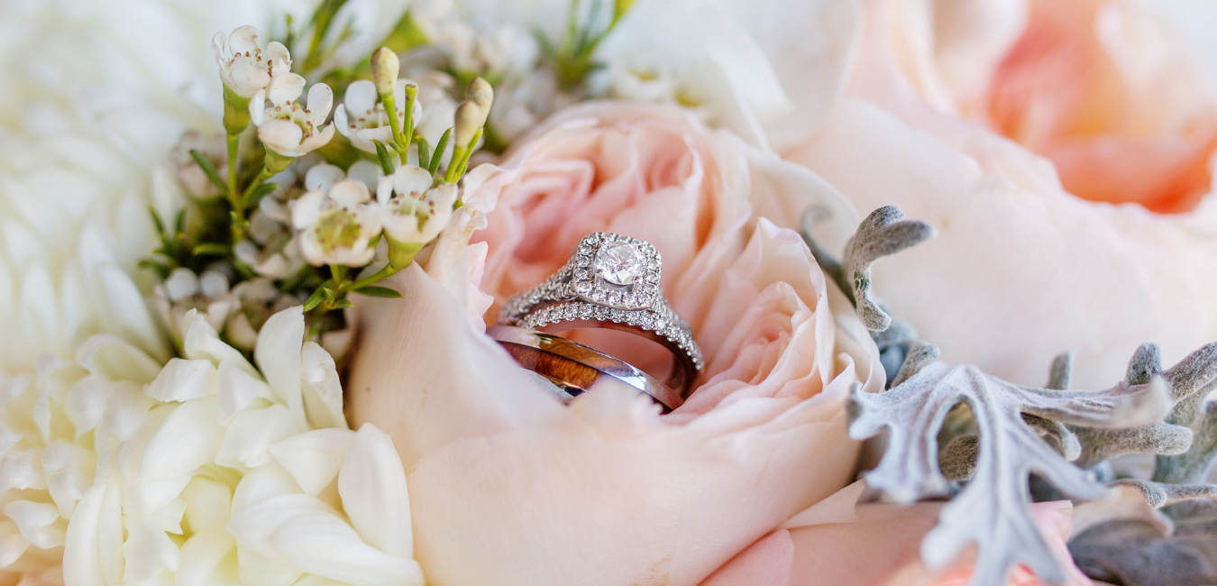 wedding rings in a pink rose